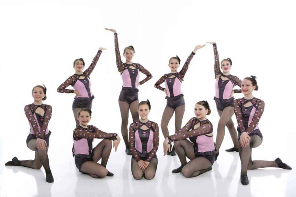 group of competitive jazz dancers in pink and black jazz costumes
